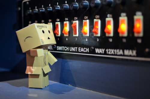 Carboard person looking at switches